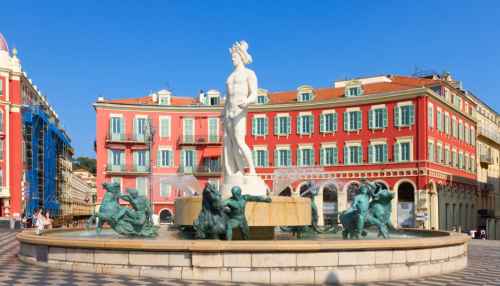 Neptune statue at Fontaine du Soleil, surrounded by classical architecture in Nice.