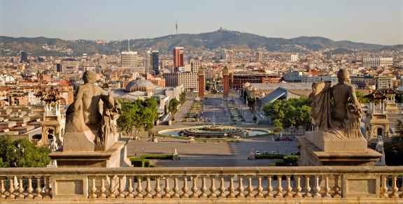 Morning light on balcony plants above a quiet street 