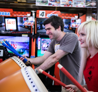 Travelers playing arcade games in Tokyo