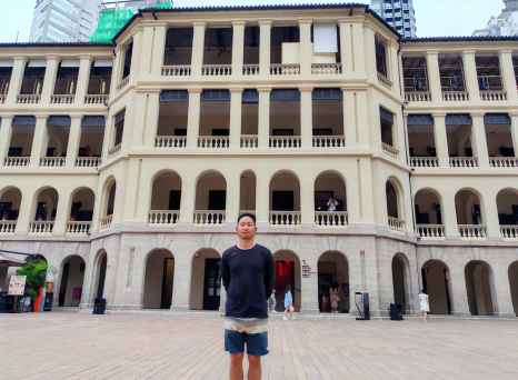 Pausing to admire the historic architecture in a Hong Kong courtyard.