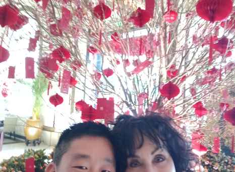 Blossoms and Smiles Amidst a Red Celebration