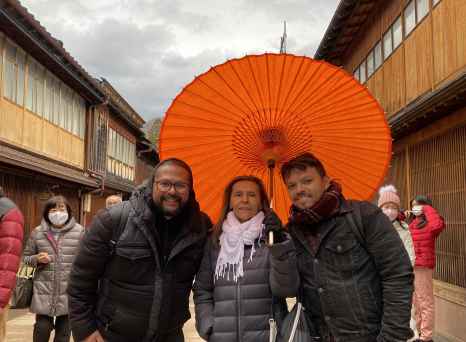 Under the Vibrant Canopy: A Warm Moment Amidst Rainy Skies