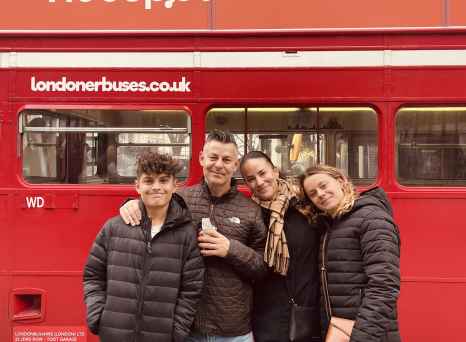 In Front of London's Iconic Red Bus: A Family Adventure