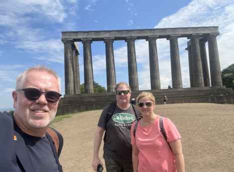 Sunshine and Smiles in Front of Majestic Columns