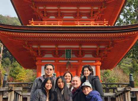 Tourists gathered at the base of the stepped roof pagoda in Kyoto.