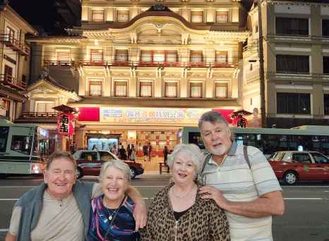 Group of people in front of Kabukiza Theatre at night.