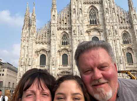 Group of three people in front of Milan Cathedral, Italy.