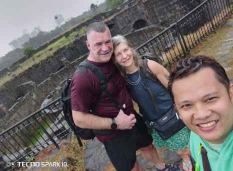 Exploring Manila's historic ruins under a cloudy sky.
