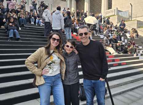 Three people posing on the steps at Sejong Center for the Performing Arts in Seoul.