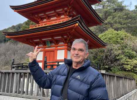 Man standing in front of the three-story pagoda at Kiyomizu-dera, Kyoto.