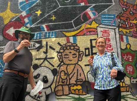 Colorful street art meets culinary delight on a lively day.