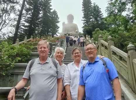 A serene moment on the steps to the Buddha.
