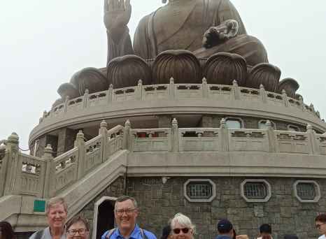 A group gathers beneath the serene gaze of Hong Kong's Buddha.