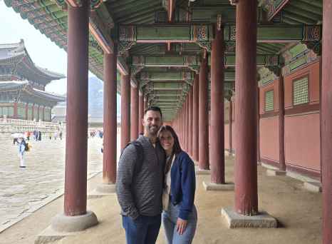 A shared moment beneath Seoul's intricately painted palace eaves.