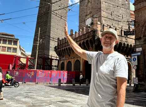 Admiring the towering heights of Bologna's historic architecture.