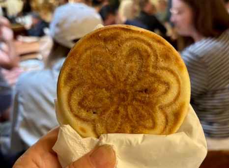 Sharing a warm pastry moment in vibrant Bologna.