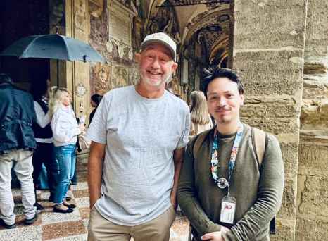 Pausing under ornate arches in a Bologna courtyard.