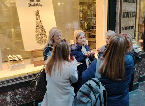 Savoring chocolate delights outside a cozy confectionery.