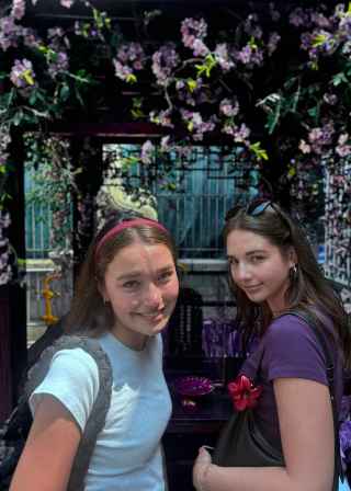 Tourists enjoying a sunny Hong Kong afternoon surrounded by vivid florals.