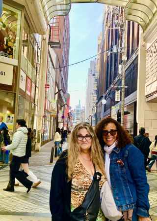 Friends pause for a photo amid the Osaka buzz.