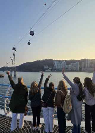 Reaching up to the sky, they embrace the sunset in Busan.