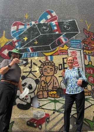 Colorful street art meets culinary delight on a lively day.