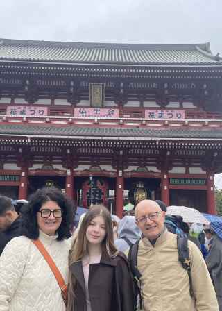 Travellers exploring historic wonders under a cloudy Tokyo sky.