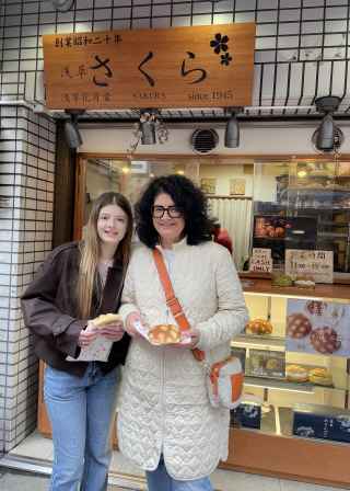 Pausing to savor local flavors in a cozy Tokyo street.