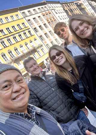 A joyous group captured against the colorful facades of Munich.