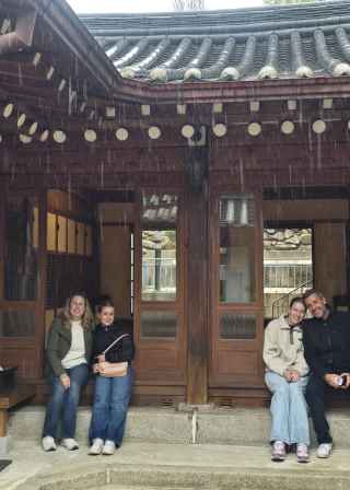 Warm smiles light up the hidden corners of a Seoul courtyard.