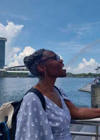 A playful moment with the Merlion's spray in Singapore.