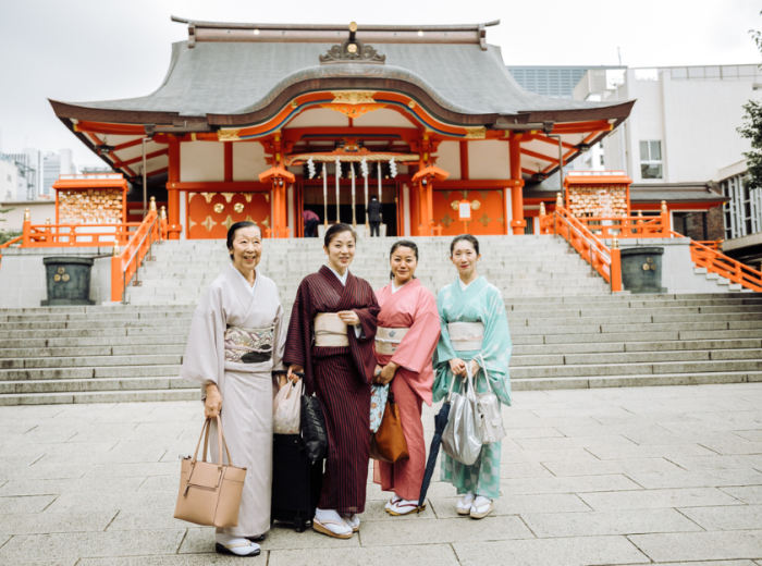 People standing in front of a temple in Tokyo, Japan