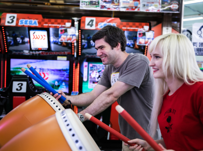 Travelers playing arcade games in Tokyo