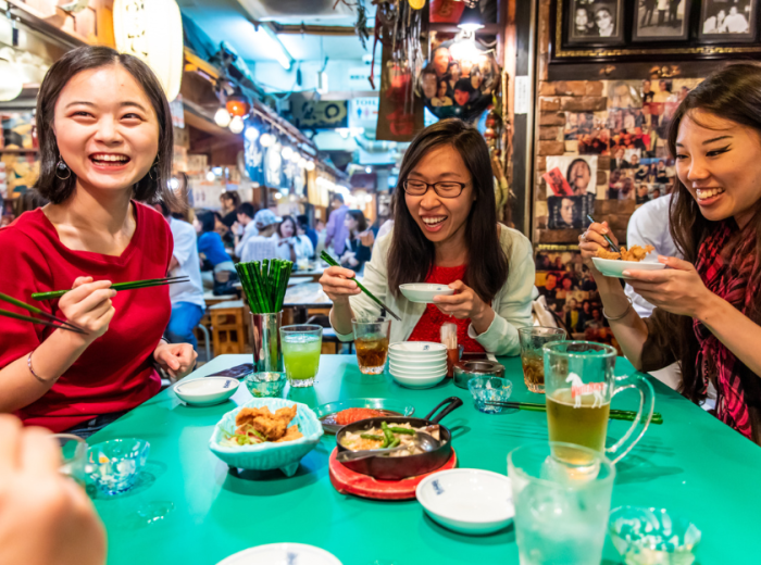 People at a restaurant, eating Japanese food
