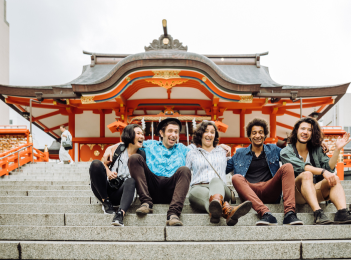 Travelers sitting in front of Hanazono-jinja Shrine