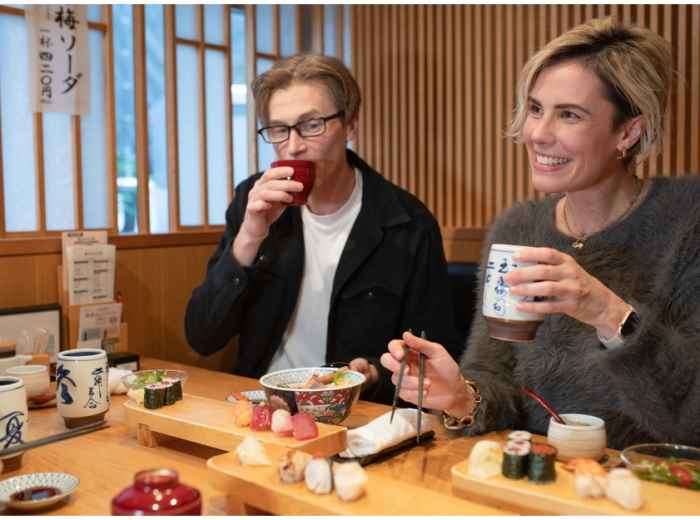 Travelers enjoying sushi in Tokyo, Japan