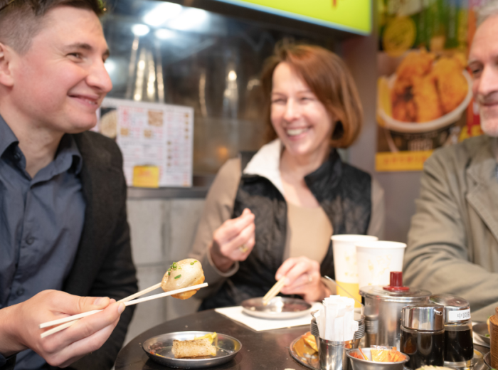Tourists enjoying Traditonal Japanese food in Japan