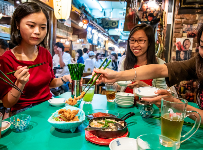 Travelers enjoying traditional Japanese food