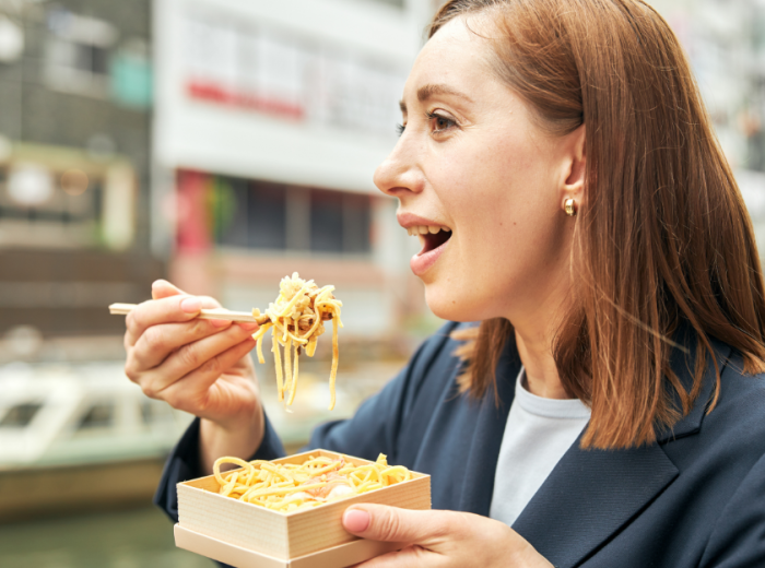 Woman enjoying the best ramen in Japan