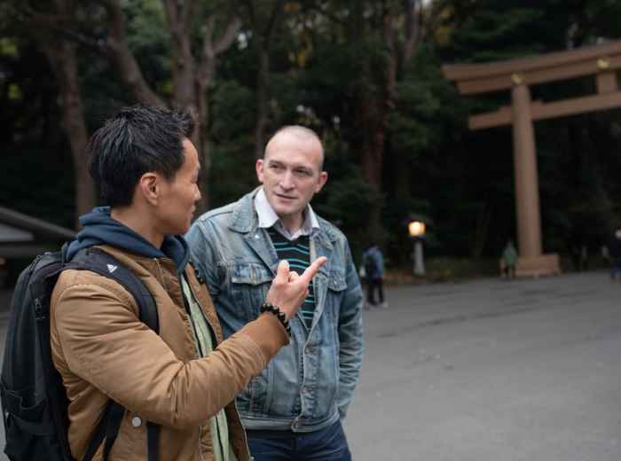 Two men standing in front of shrine