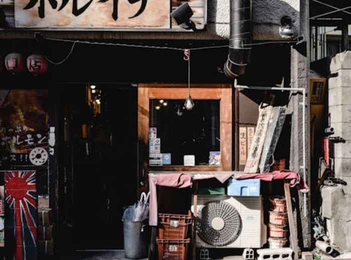 Exterior of small gyoza shop with handwritten signage.