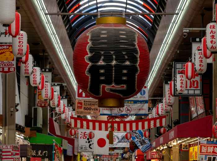 Covered arcade signage with hanging lanterns. Photo by 5010 on Unsplash