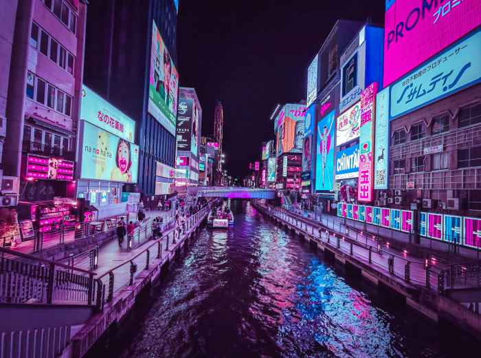 Neon lights reflecting off water photo by  Senad Palic on Unsplash
