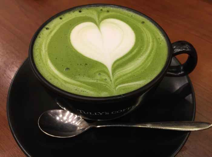 Latte with matcha swirl on wooden table outdoors Image by hoyas from Pixabay