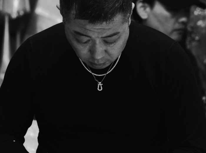 Chef slicing fish at market Photo by Noe Garde on pexels