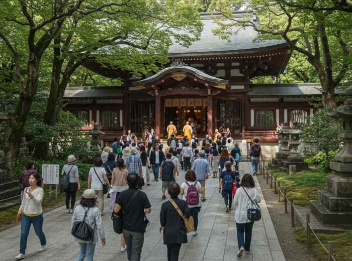 Tourists rushing through temple grounds missing monk ceremony.