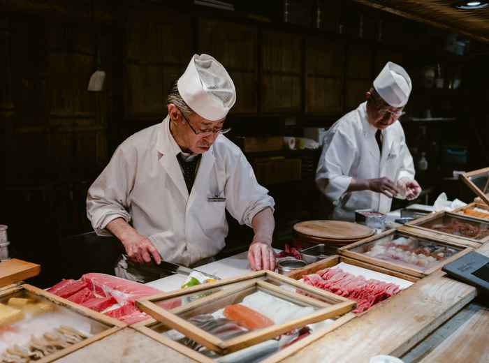 Vendor slicing vegetables with precision. Image by Fabio Sasso from Unsplash