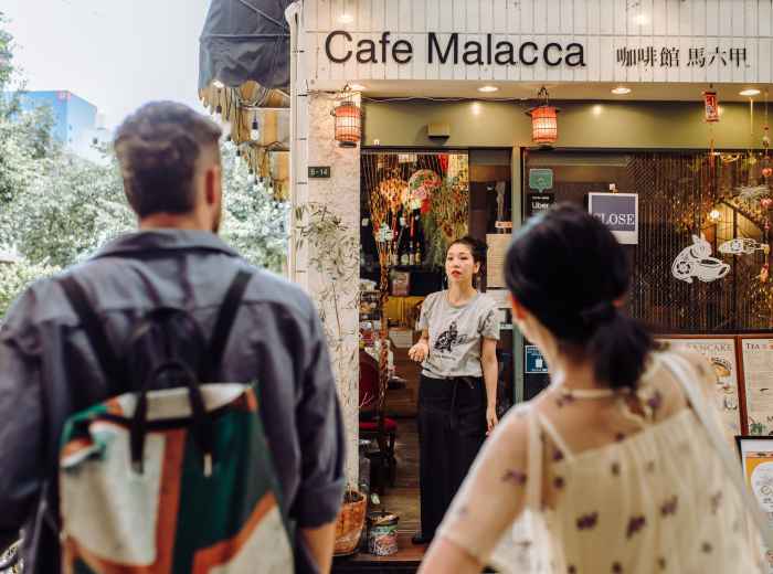 Guests and a host planning a route at a café.