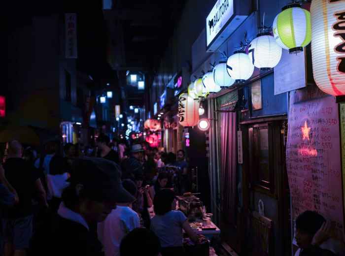 Namba's neon-lit streets with crowds of people shopping and eating Photo by Alex Knight on Unsplash