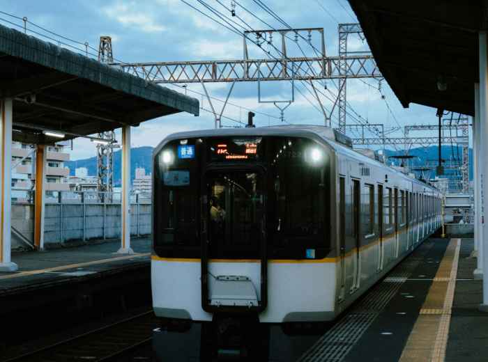Clean, modern airport express train at platform in Osaka Station Photo by Peter Thomas on Unsplash
